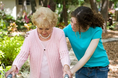 A girl helping an old women